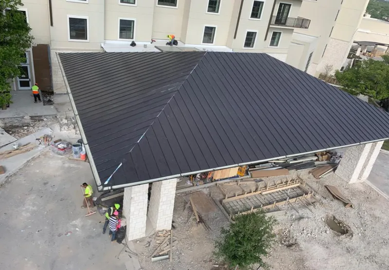Metal roofing installation team working on a commercial building in Yuma